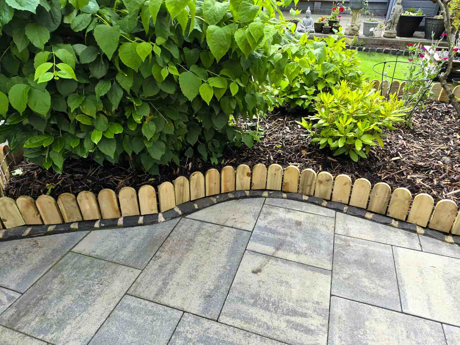 Wooden lawn edging used along a curved flower bed